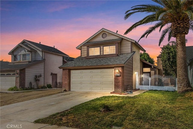 view of property featuring a yard and a garage