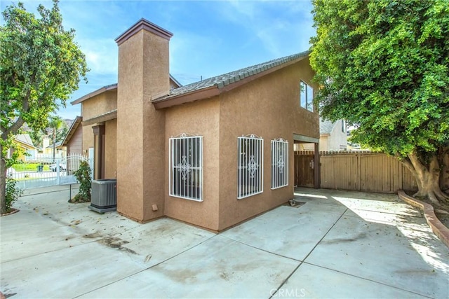 back of property featuring a patio area and central air condition unit