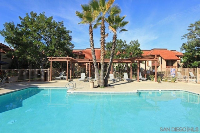 view of pool with a pergola and a patio area