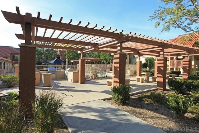 view of property's community featuring a pergola and a patio