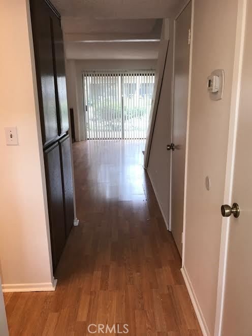 hall with dark hardwood / wood-style floors