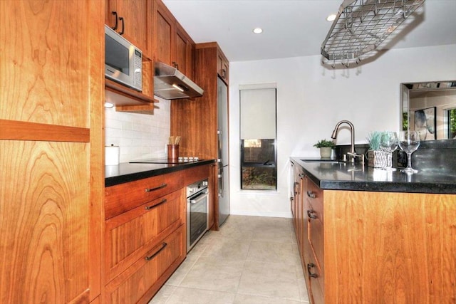 kitchen with decorative backsplash, sink, light tile patterned floors, and stainless steel appliances