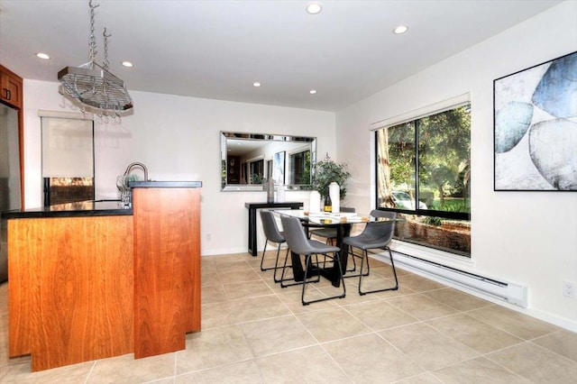 tiled dining room featuring a chandelier and a baseboard radiator