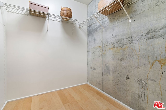 walk in closet featuring hardwood / wood-style flooring