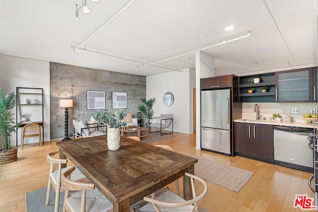 dining space featuring sink and light hardwood / wood-style flooring