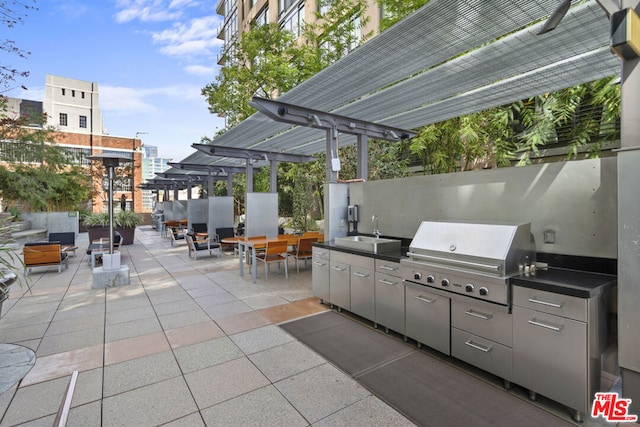 view of patio / terrace with a pergola, sink, exterior kitchen, and a grill