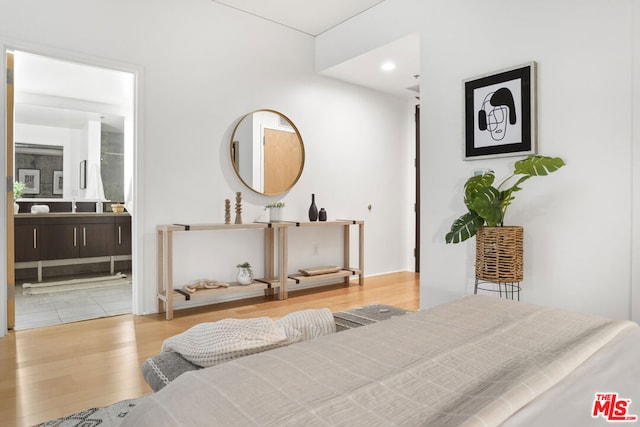 bedroom featuring hardwood / wood-style floors and connected bathroom