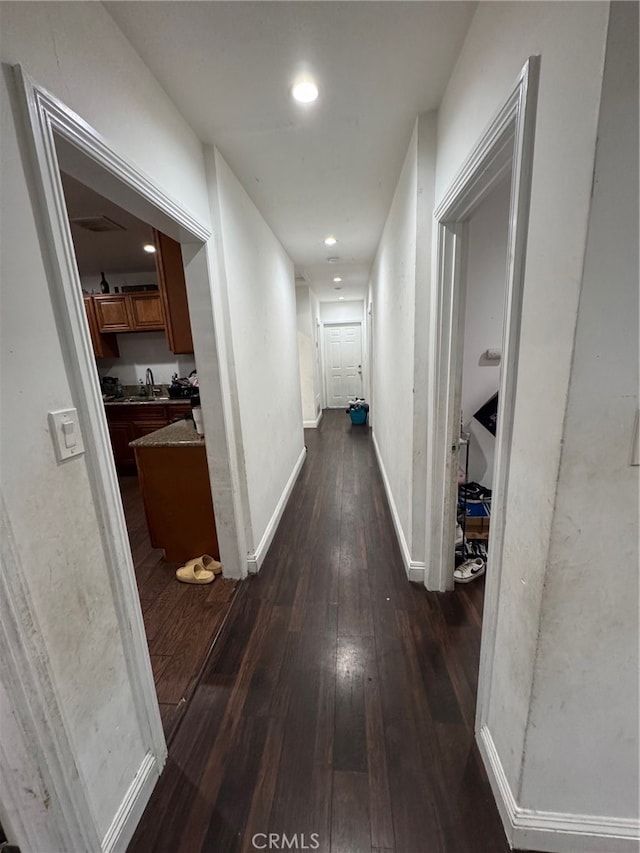 hallway featuring sink and dark hardwood / wood-style flooring