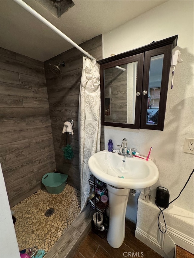 bathroom featuring a shower with curtain and hardwood / wood-style flooring