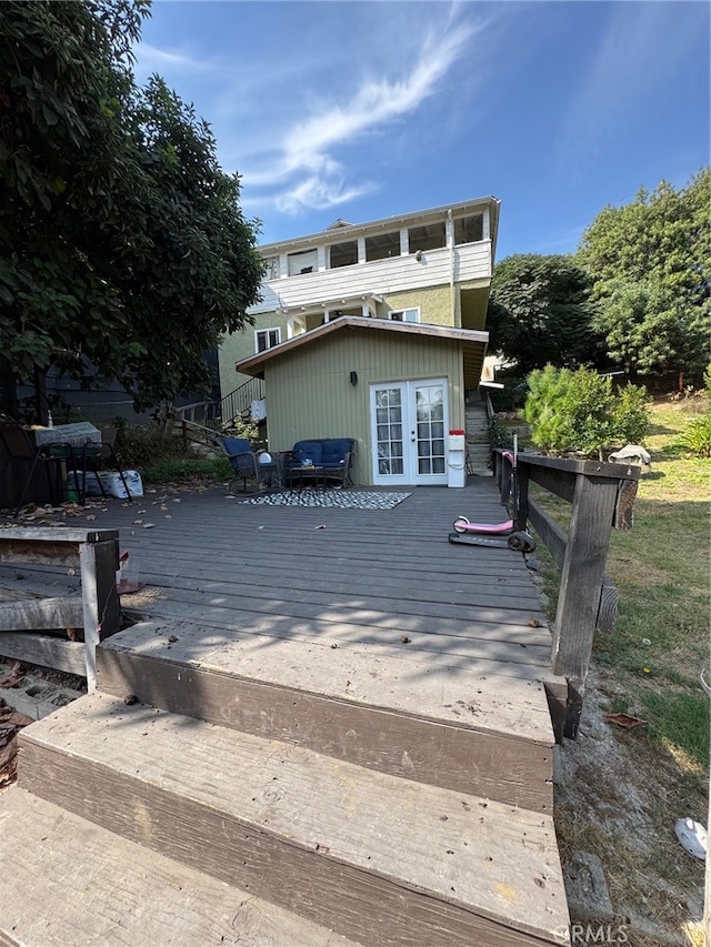 back of property with a wooden deck and french doors