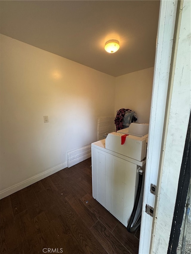 laundry area with dark wood-type flooring