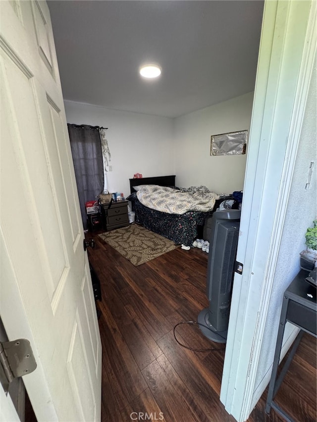 bedroom with dark hardwood / wood-style floors