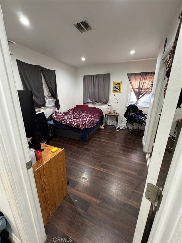 bedroom with dark wood-type flooring