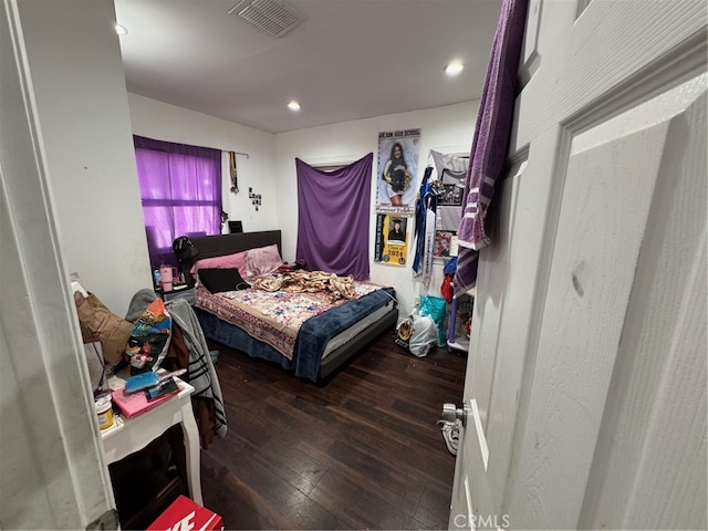 bedroom with dark hardwood / wood-style flooring