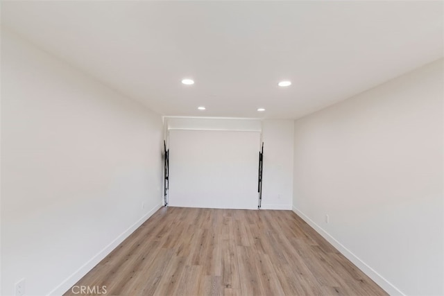 spare room with light hardwood / wood-style flooring