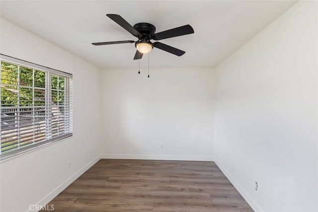 unfurnished room with ceiling fan and dark hardwood / wood-style floors