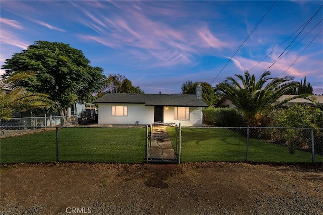 ranch-style home with a yard