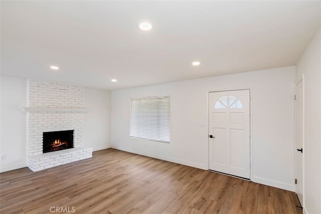 entryway featuring light hardwood / wood-style flooring and a fireplace