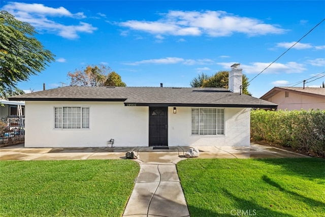 ranch-style home with a front lawn