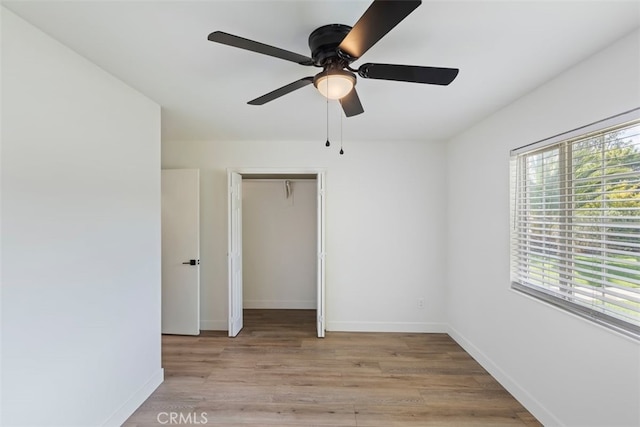 unfurnished bedroom with a closet, ceiling fan, and light wood-type flooring