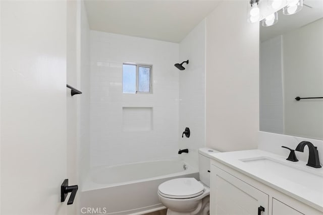 full bathroom featuring tiled shower / bath, vanity, and toilet