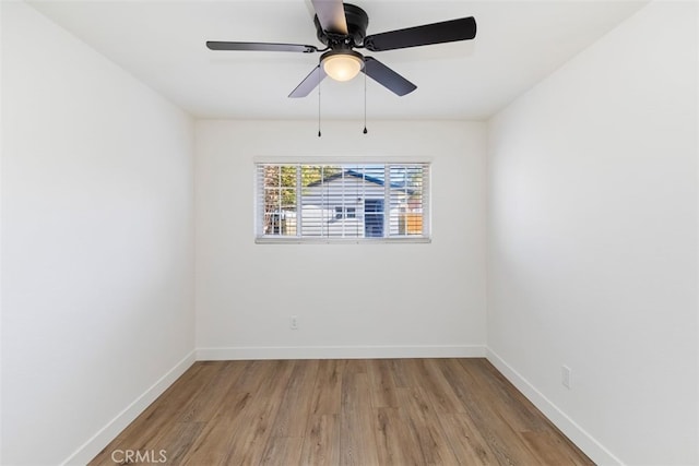 spare room featuring hardwood / wood-style floors and ceiling fan