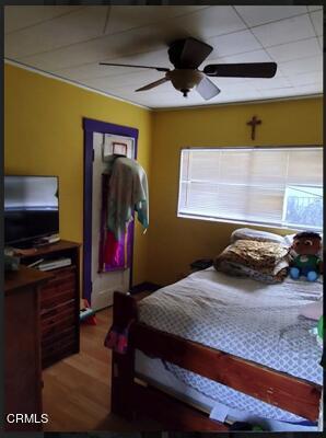 bedroom with wood-type flooring and ceiling fan