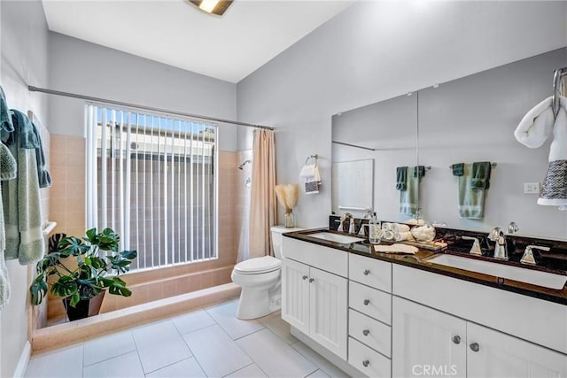 bathroom with a shower with curtain, vanity, toilet, and tile patterned floors