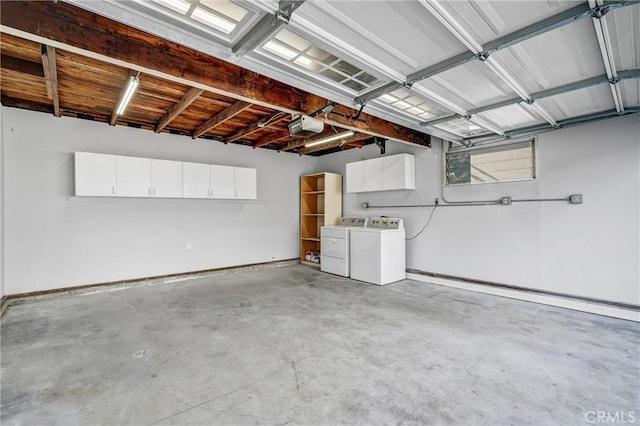 garage featuring a garage door opener and washing machine and clothes dryer