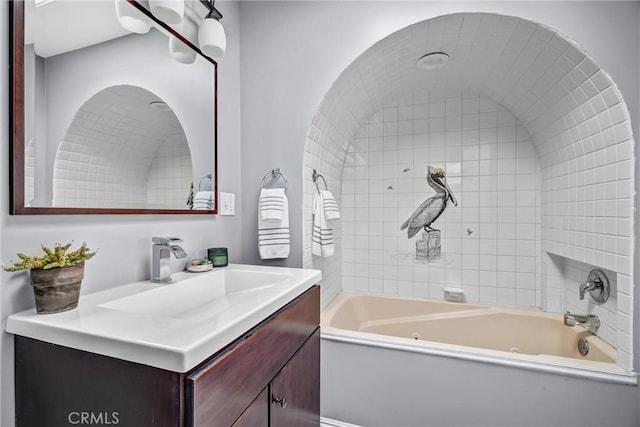 bathroom featuring vanity and tiled shower / bath combo