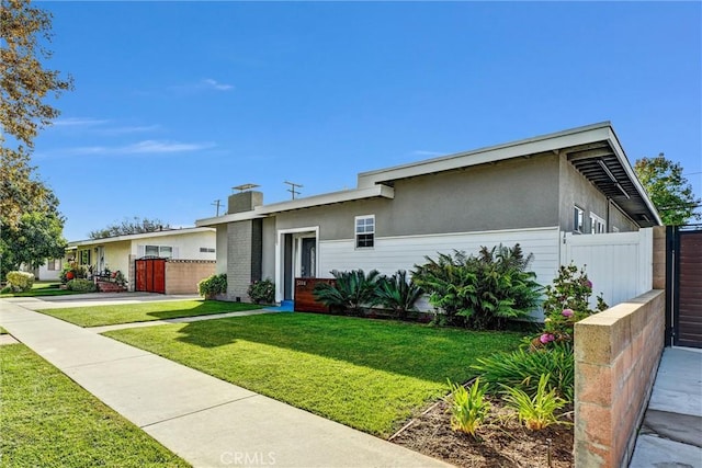 ranch-style house with a front lawn