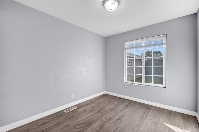 spare room featuring hardwood / wood-style floors