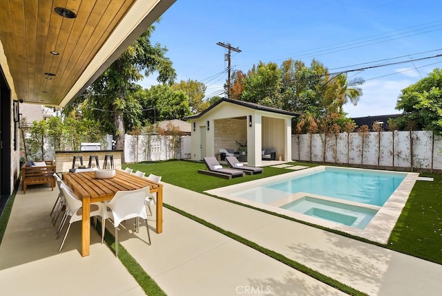 view of pool featuring a patio, a yard, and an outdoor structure