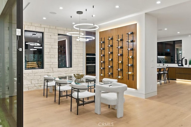 interior space with light wood-type flooring and a notable chandelier