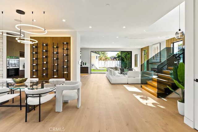 living room featuring light hardwood / wood-style flooring and a notable chandelier