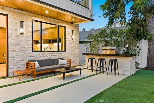 view of patio with exterior bar, a grill, an outdoor kitchen, and an outdoor living space