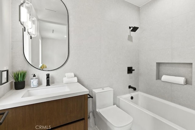 full bathroom featuring toilet, vanity, tile walls, and  shower combination