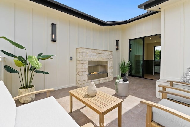 view of patio with an outdoor stone fireplace