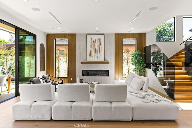 living room with wood walls and a fireplace