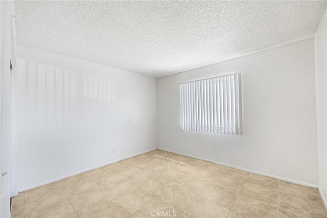 empty room featuring a textured ceiling