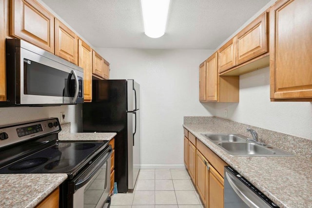 kitchen featuring sink, appliances with stainless steel finishes, and light tile patterned floors