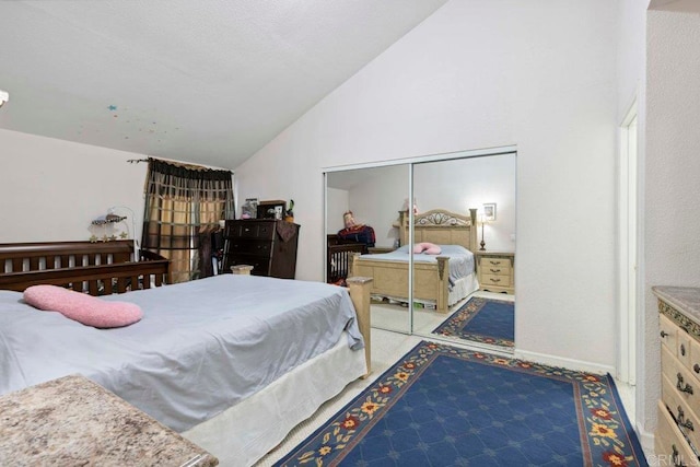 carpeted bedroom with high vaulted ceiling and a closet