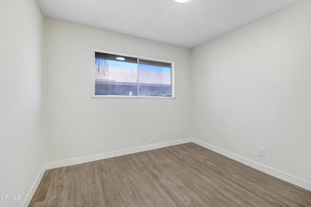 spare room with hardwood / wood-style flooring