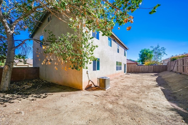 back of house featuring central AC