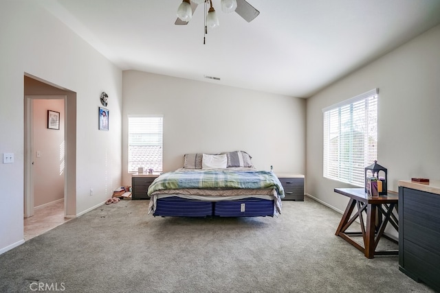 carpeted bedroom featuring vaulted ceiling and ceiling fan