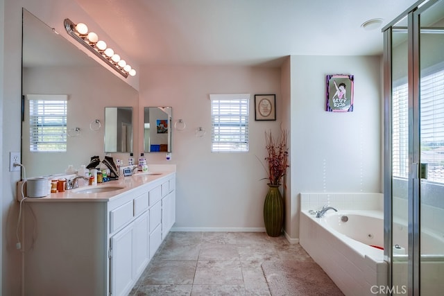 bathroom featuring plus walk in shower, vanity, and a healthy amount of sunlight