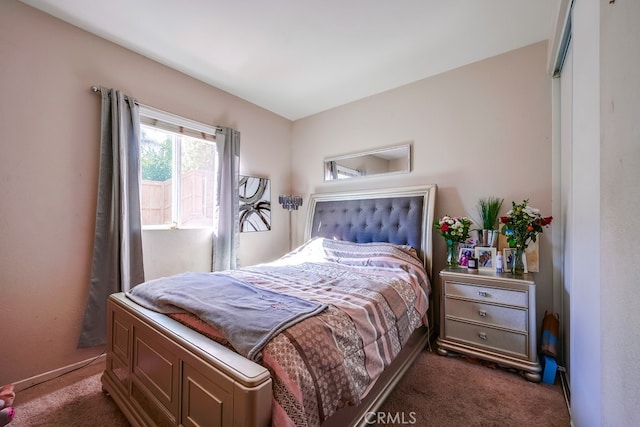 bedroom featuring dark colored carpet