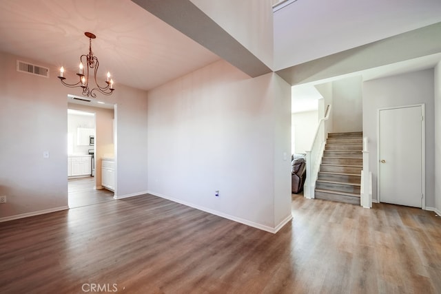 interior space with hardwood / wood-style flooring and a notable chandelier