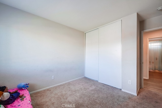 unfurnished bedroom featuring light colored carpet