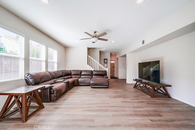 living room featuring light hardwood / wood-style floors and ceiling fan